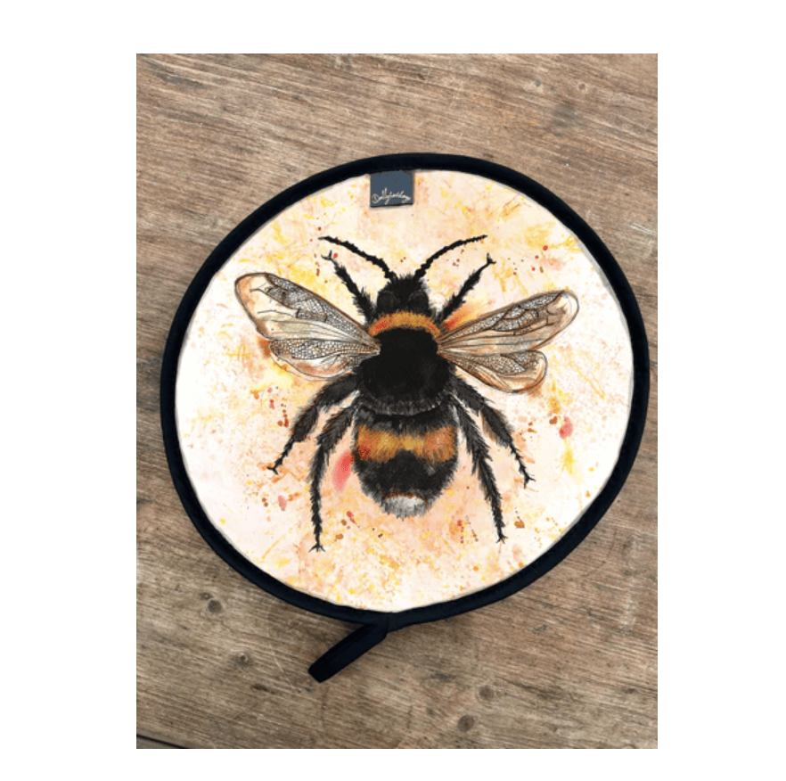 Aga Cover with a bee design on a wooden surface