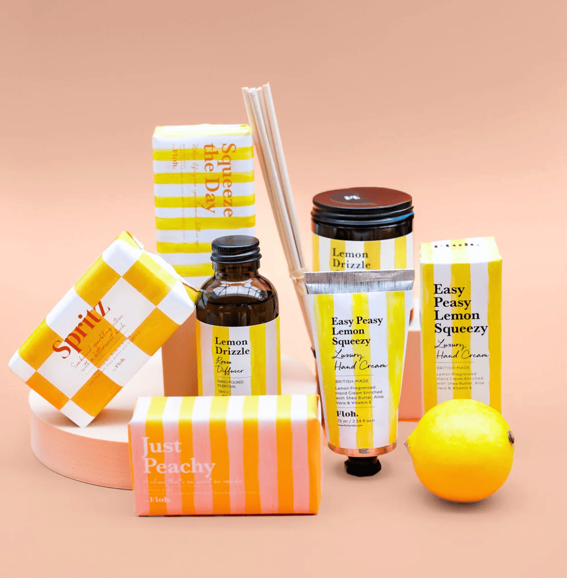 Collection of lemon-themed skincare and home fragrance products on a beige background