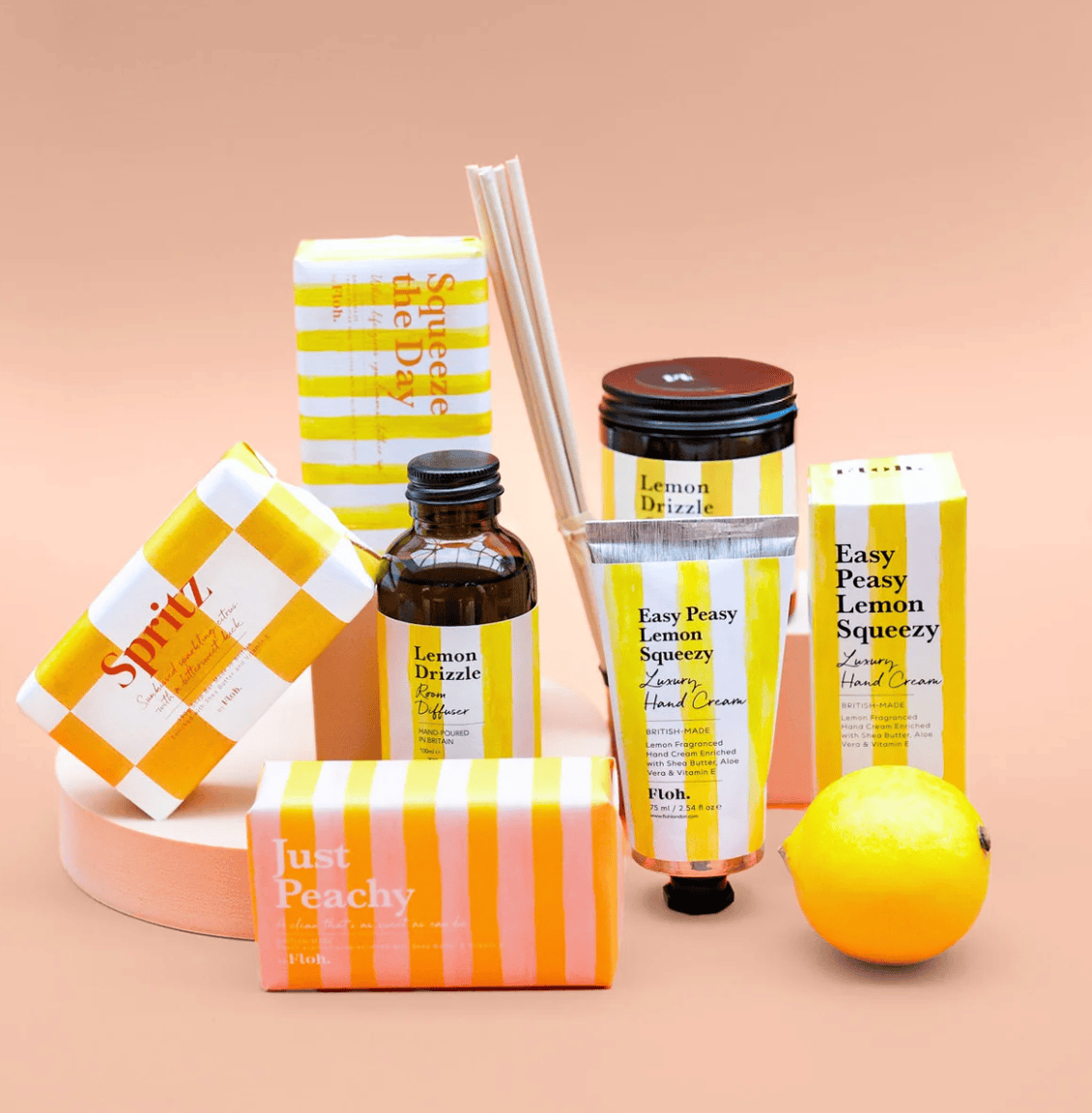 Collection of lemon-themed skincare and home fragrance products on a beige background