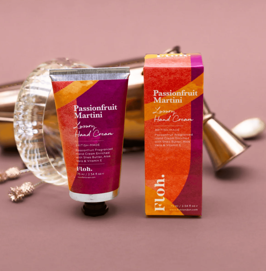 Passionfruit Martini hand cream with packaging on a decorative background