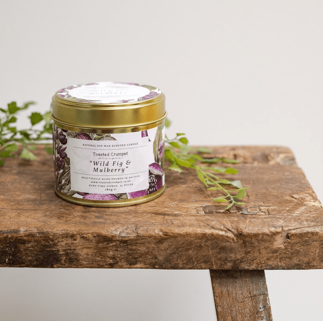 Wild Fig & Mulberry Gold Tin Candle by Toasted Crumpet on a bench