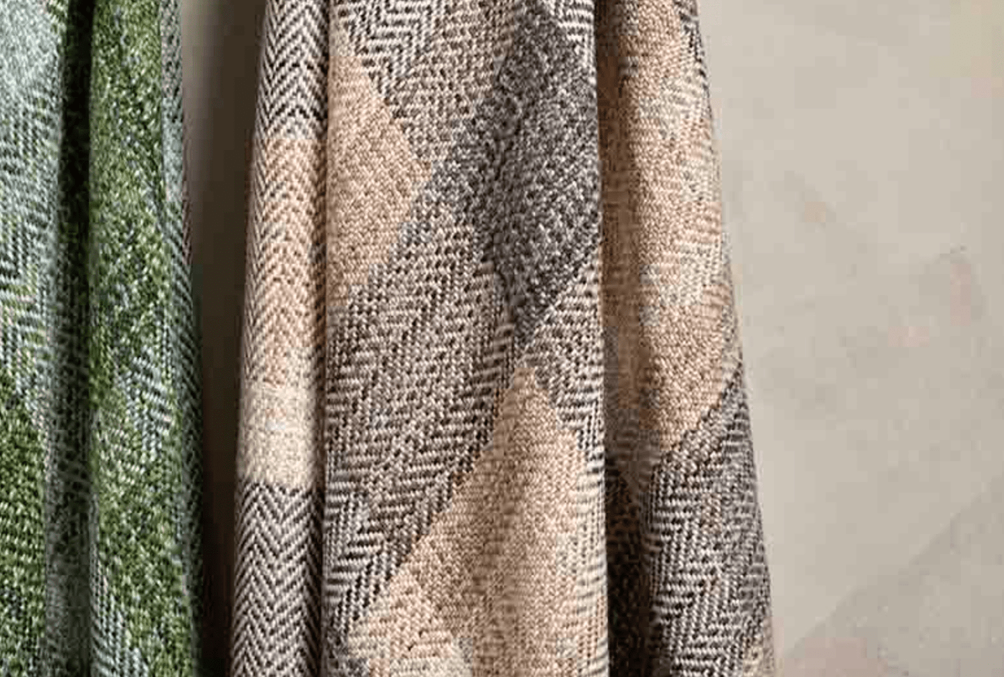 Textured fabric swatches in green, beige, and patterned design on a gray background