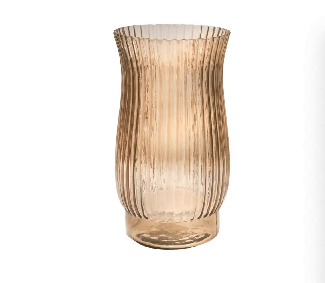 Glass vase with ribbed texture on a white background