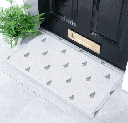 Doormat with tree pattern in front of a black door