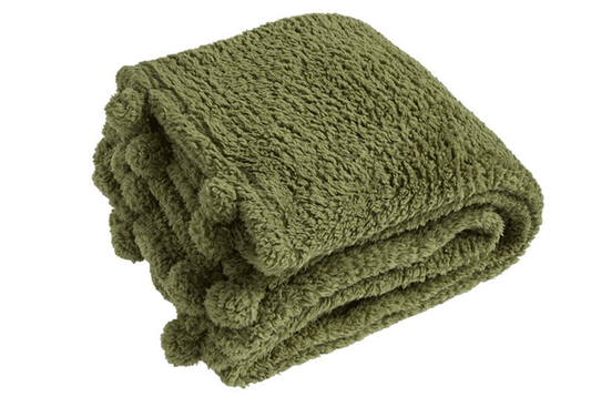 Folded green blanket on a white background