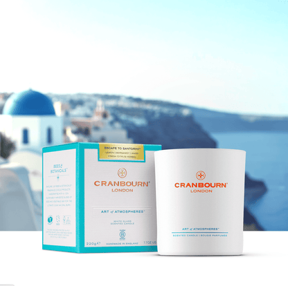 Cranbourn London Escape to Santorini White Candle and Box with Santorini background.