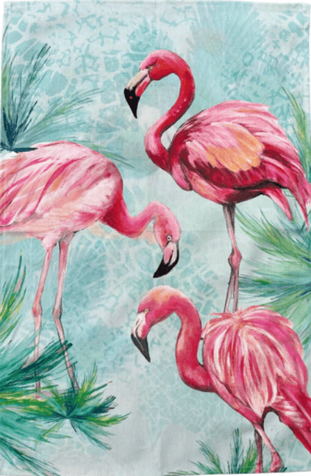 Three pink flamingos in a tropical setting with green foliage on a light blue background