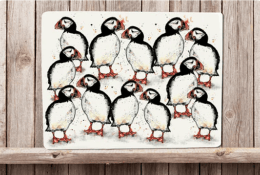 Placemat with a design of puffins on a wooden surface