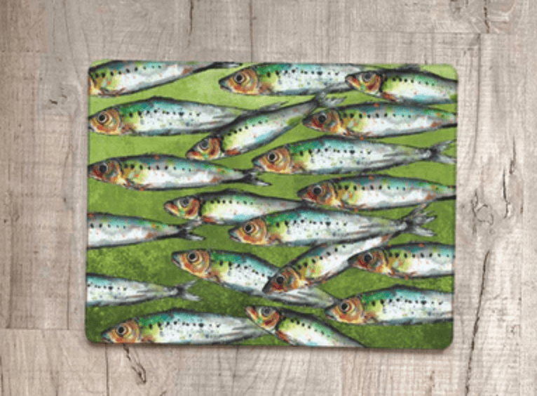 Placemat with fish pattern on a wooden surface