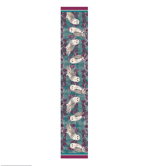 A narrow rectangular textile or rug sample shown flat against a white background, featuring a repeating owl pattern on a teal ground with pink and purple floral accents and magenta borders at the top and bottom.