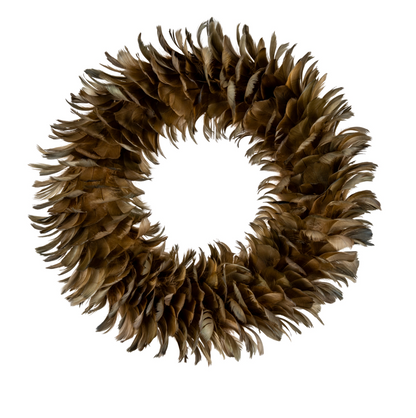 A circular decorative wreath made of layered brown feathers, photographed against a solid white background.