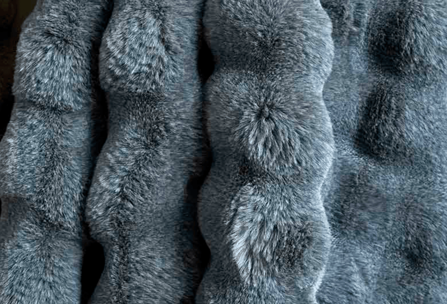 Close-up of textured slate blue faux fur throw