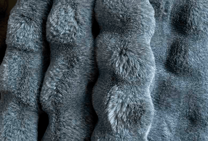 Close-up of textured slate blue faux fur throw