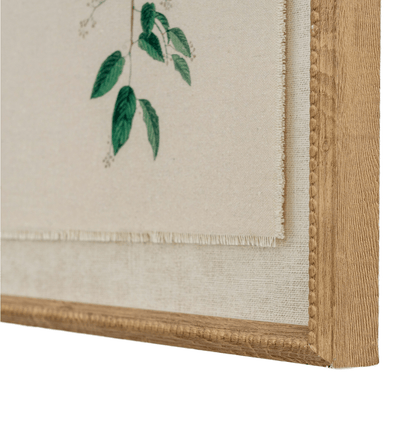 Framed artwork with green leaves on a beige background