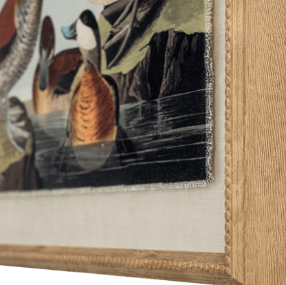 Close-up of a framed painting of ducks on a lake