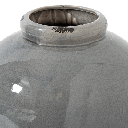 Close-up of a gray ceramic vase with a textured surface on a white background