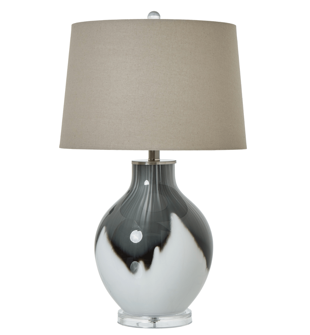 Table lamp with gray and white base and beige shade on a white background
