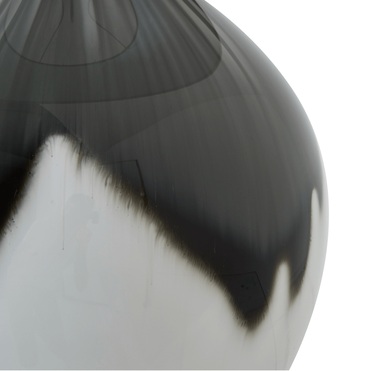 Close-up of a glossy black and white vase on a white background