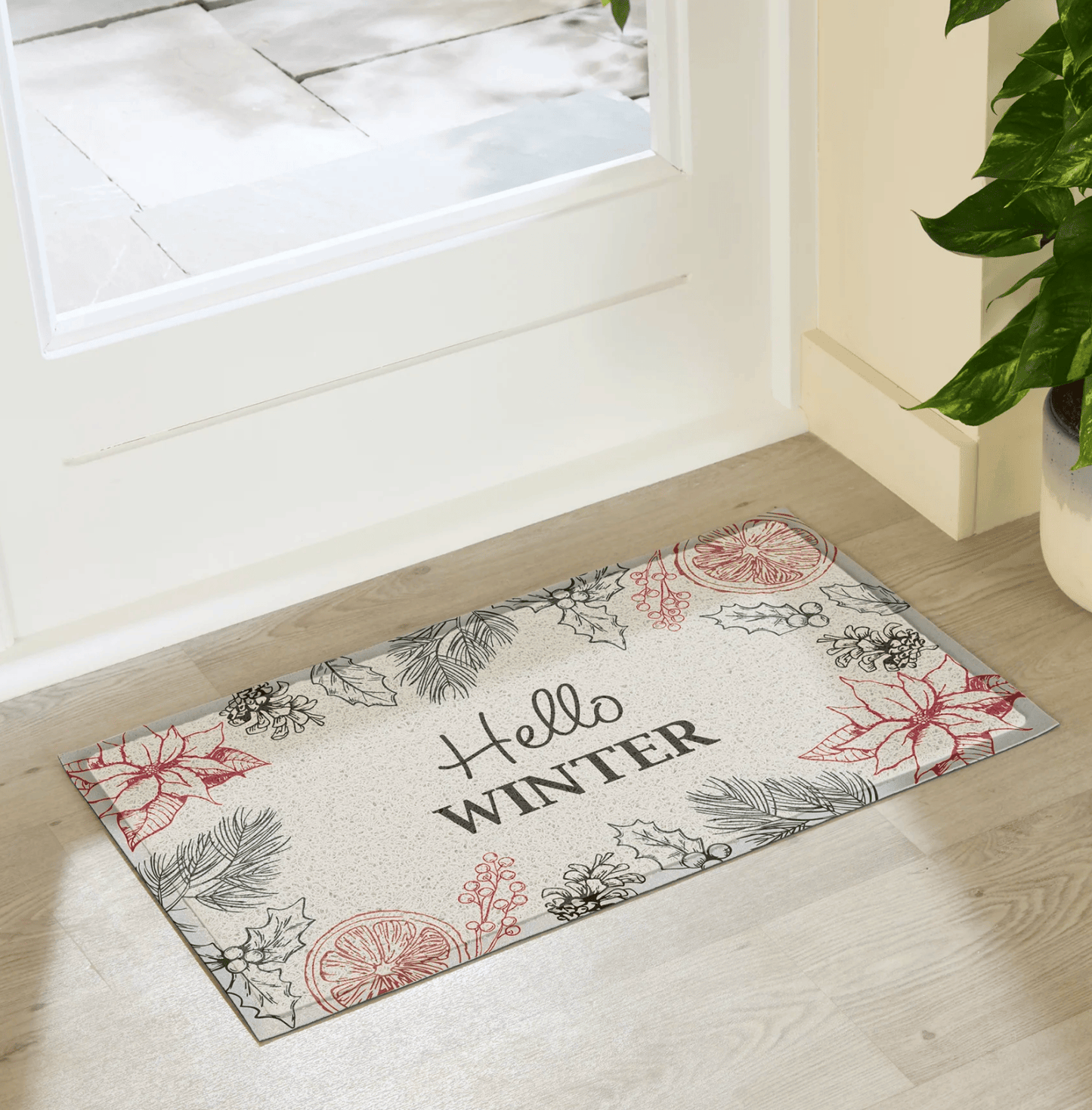 Decorative doormat with 'Hello Winter' text on a wooden floor.