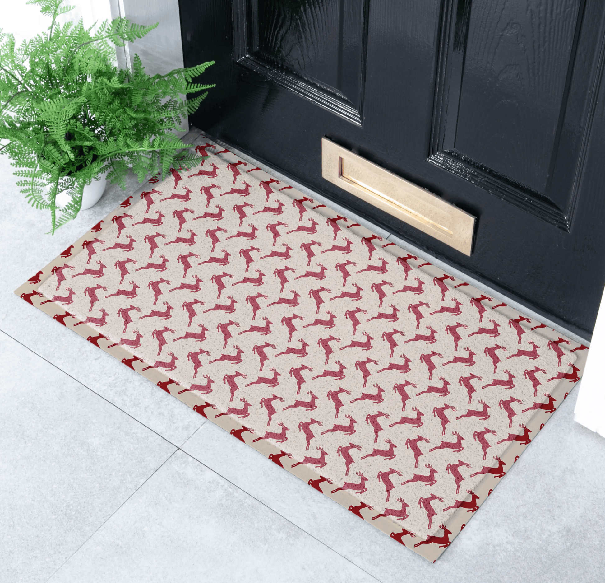 Doormat with red dog pattern in front of a black door
