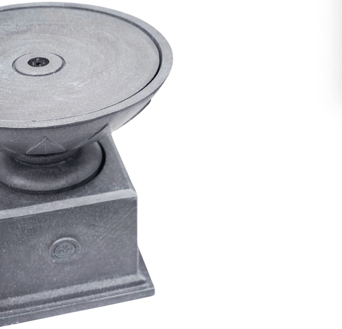 A close-up of a dark gray cast iron outdoor pedestal base with a circular top plate and a square pedestal foundation, shown on a plain white background.