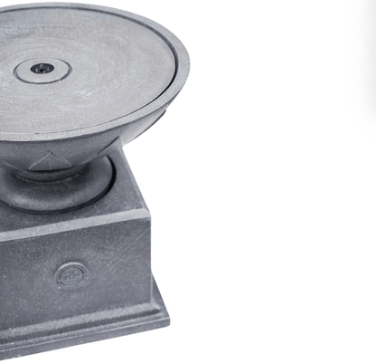 A close-up of a dark gray cast iron outdoor pedestal base with a circular top plate and a square pedestal foundation, shown on a plain white background.