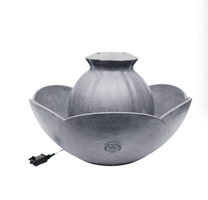 A gray textured ceramic lotus-shaped tabletop fountain with a central dome and a small black power cord on a white background.