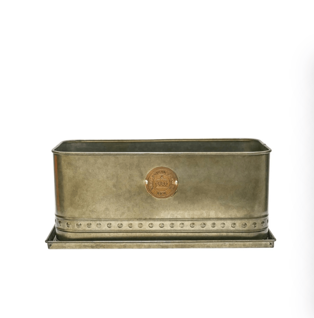 Bronze planter with a circular emblem on a white background