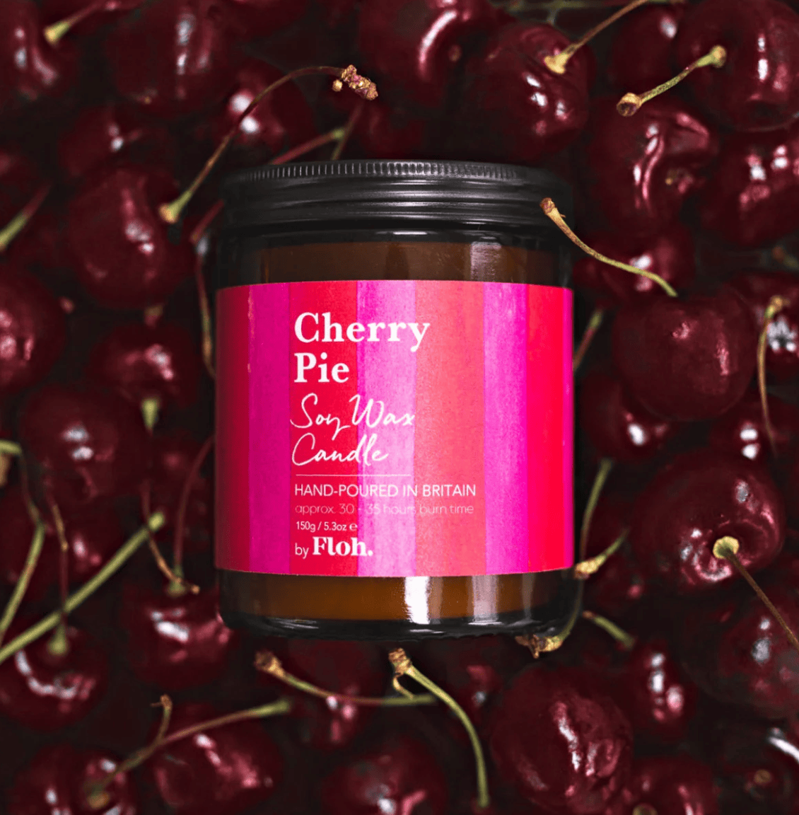Candle jar labeled 'Cherry Pie' surrounded by cherries