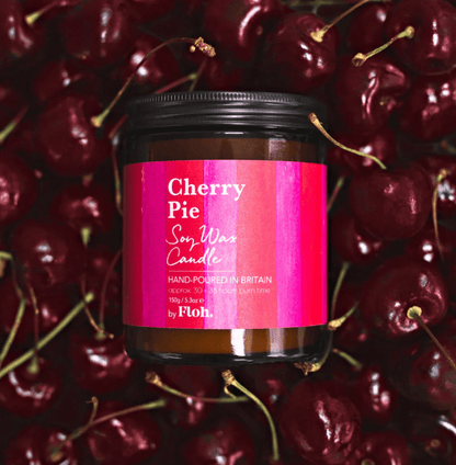 Candle jar labeled 'Cherry Pie' surrounded by cherries