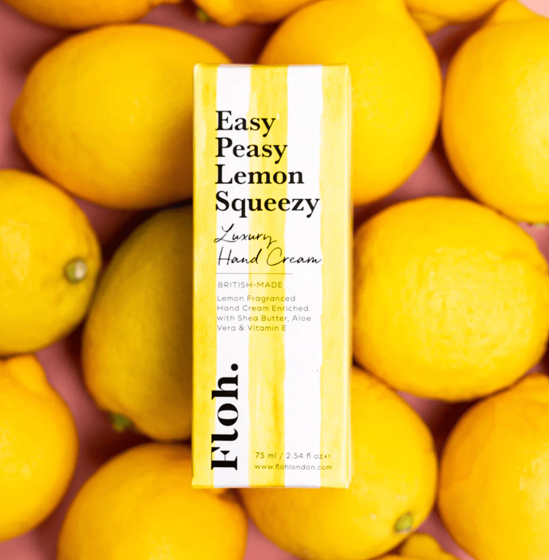 Hand cream packaging labeled 'Easy Peasy Lemon Squeezy' surrounded by lemons