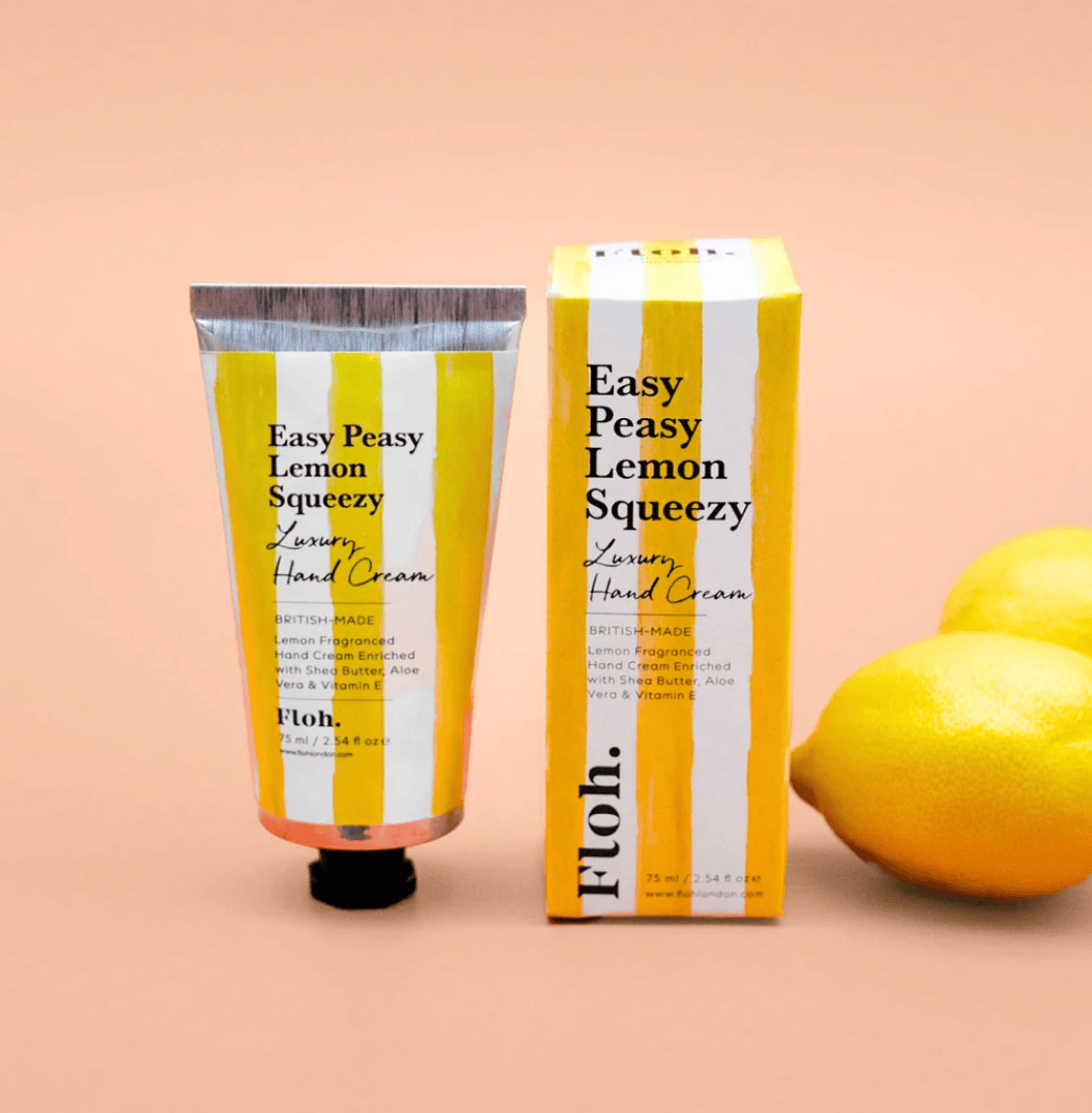 Hand cream and packaging with lemons on a beige background