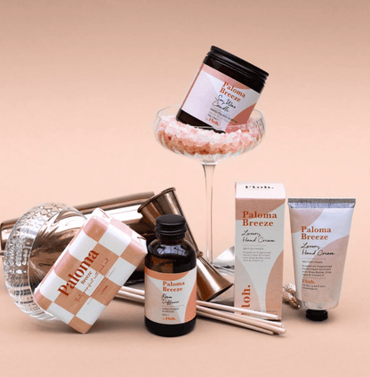 Collection of Paloma Breeze skincare products on a beige background