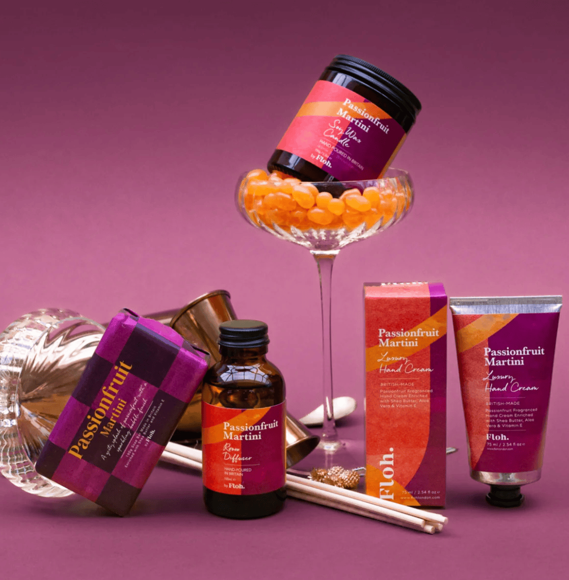 Passionfruit Martini themed products including a bottle, box, and cream on a purple background