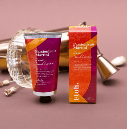Passionfruit Martini hand cream with packaging on a decorative background