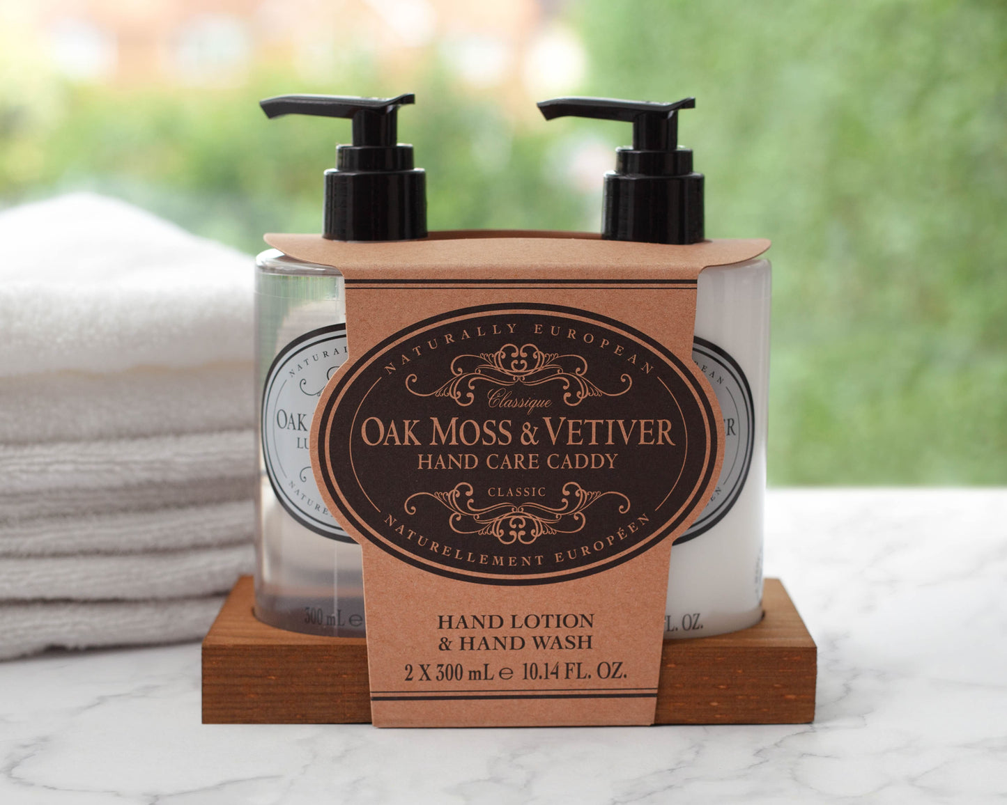 Hand care caddy with Oak Moss & Vetiver hand cream and wash on a marble surface.