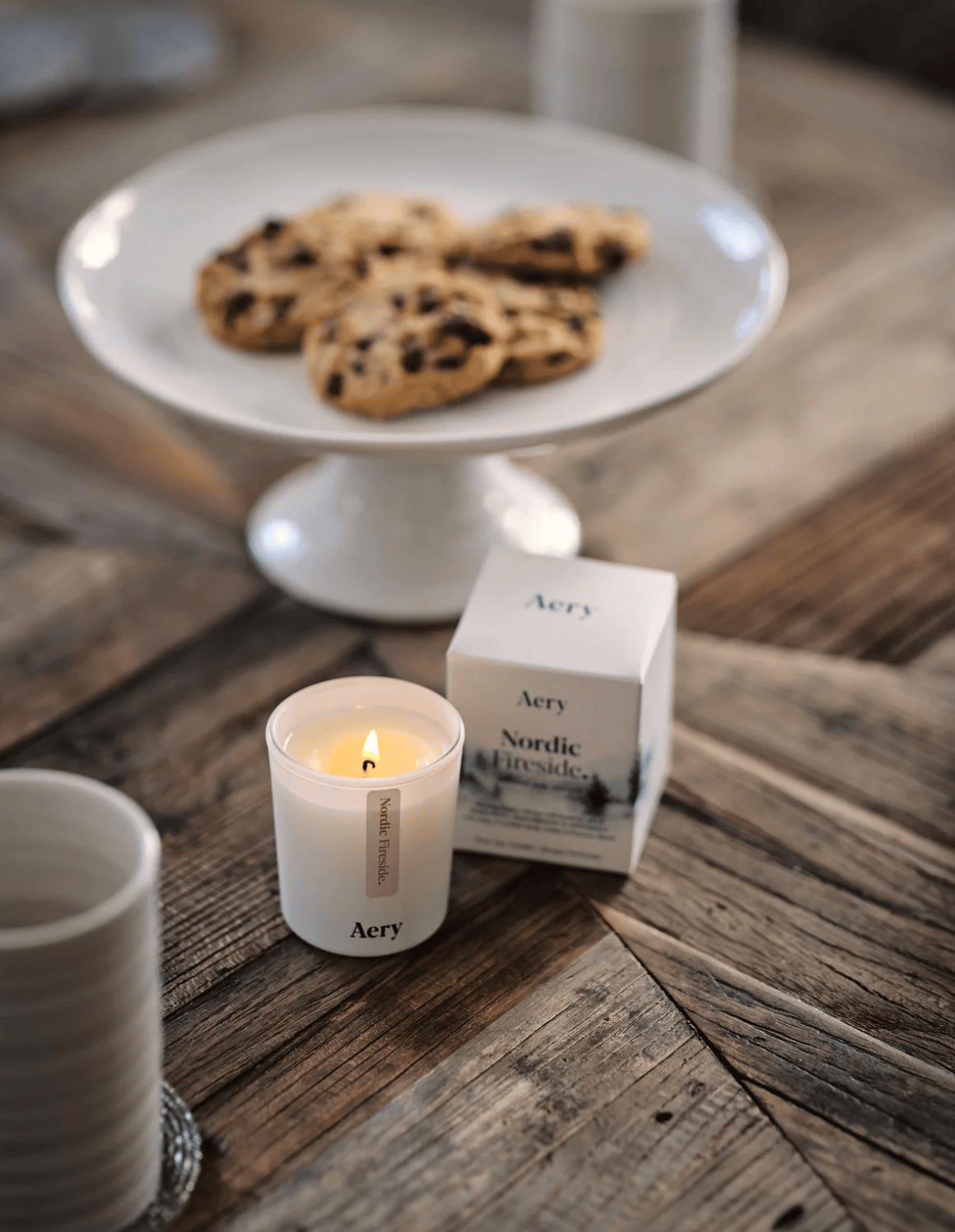 Aery candle and cookies on a wooden table