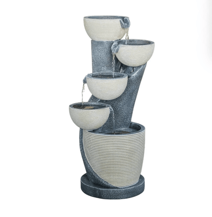 A multi-tiered outdoor water fountain with a textured dark gray stone-like body and cream-colored bowl basins, shown against a plain white background.