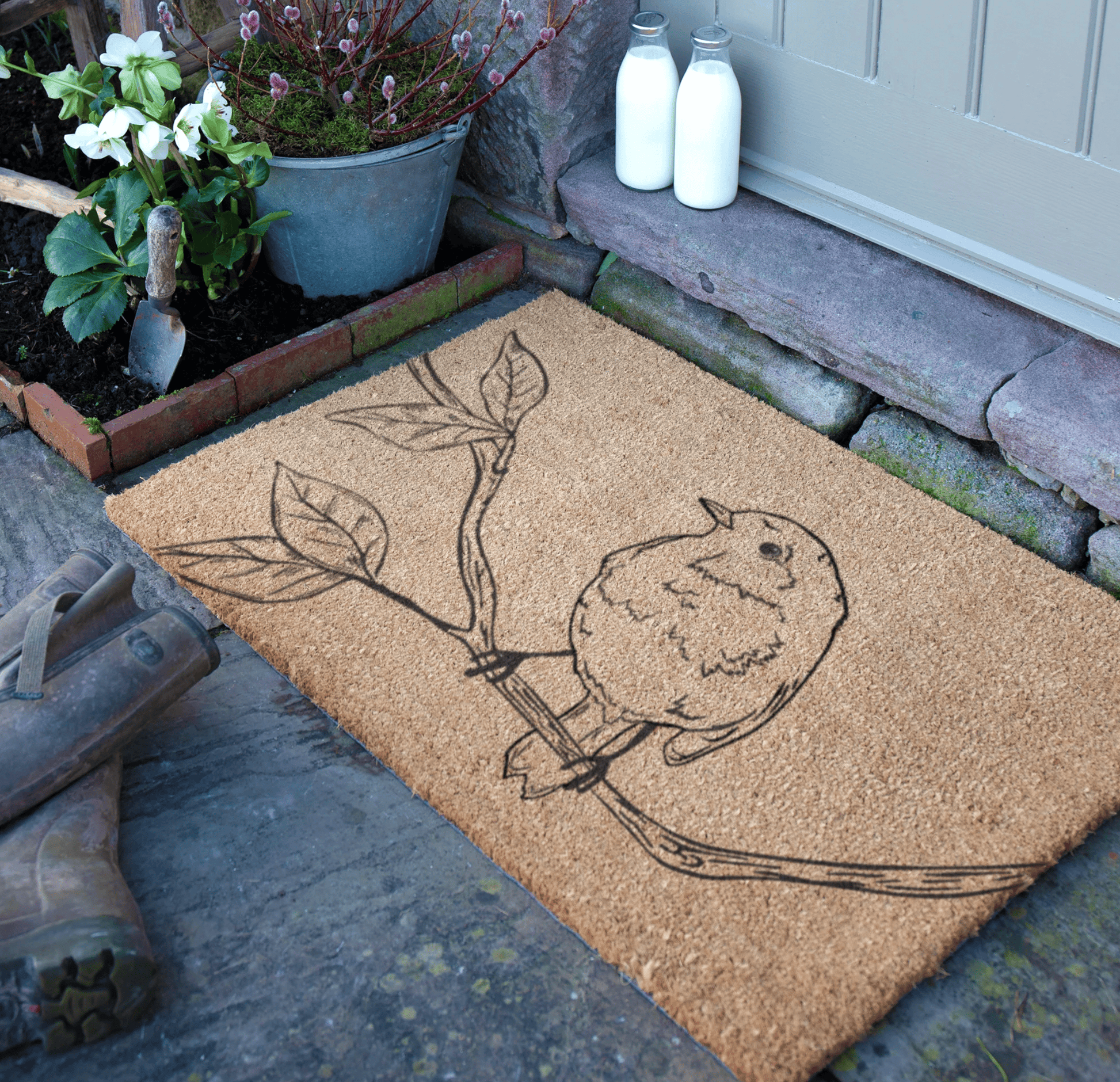 Doormat with a bird design on a stone step outside a house.