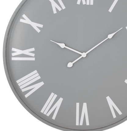 Grey wall clock with white Roman numerals on a white background