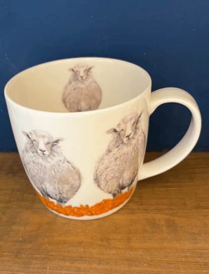 Mug with sheep design on a wooden surface and blue background