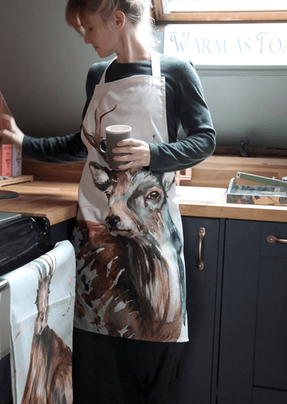 Person wearing a wolf-themed apron in a kitchen setting