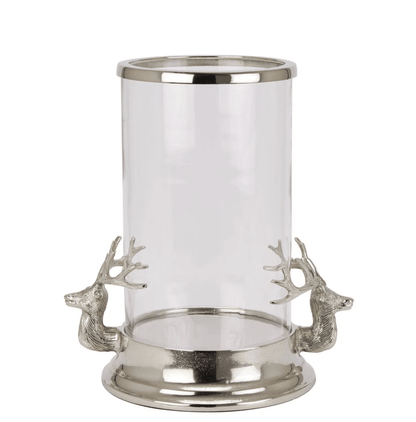 Clear glass candle holder with silver metal base and deer heads on a white background