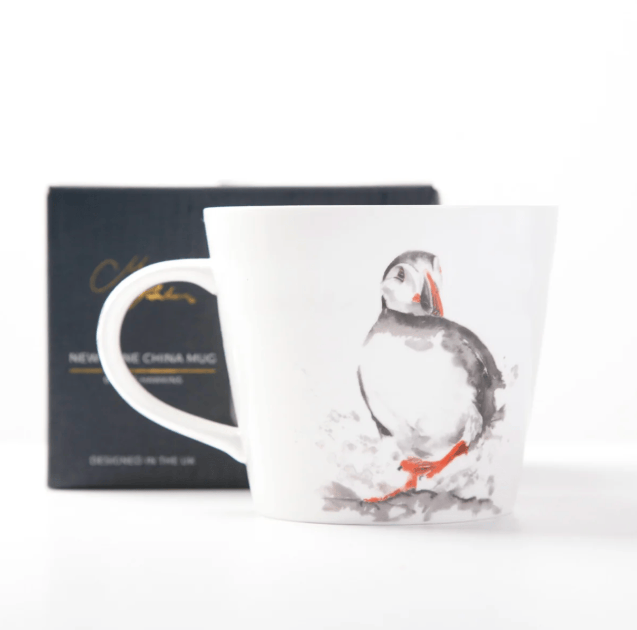 White mug with a Puffin design on a white background