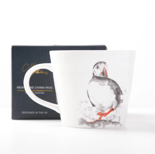 White mug with a Puffin design on a white background
