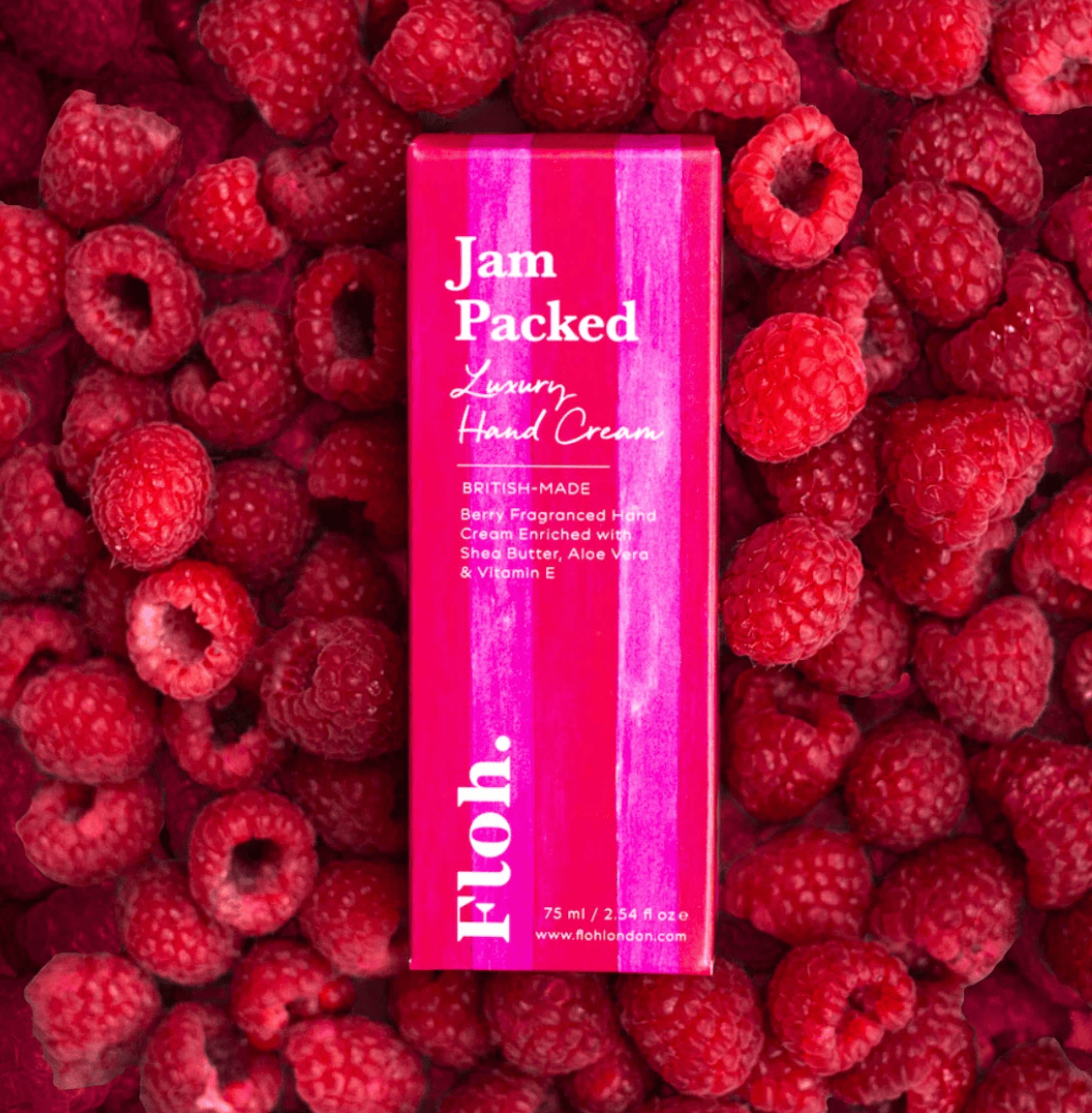 Hand cream box labeled 'Jam Packed' surrounded by raspberries