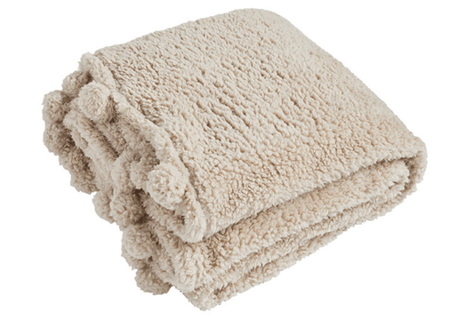 Beige sherpa blanket on a white background