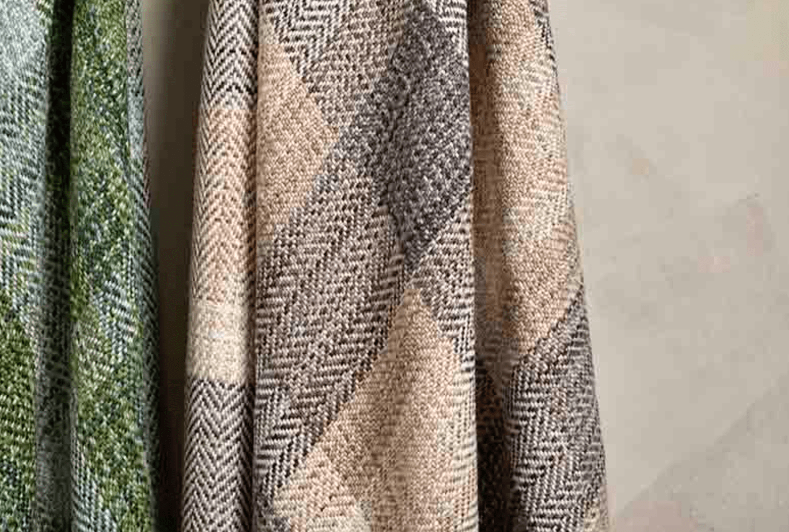 Textured fabric swatches in green, beige, and patterned design on a gray background