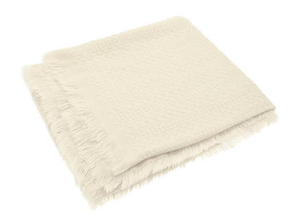 Beige fluffy blanket on a white background