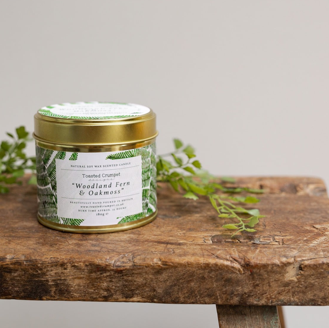 Toasted Crumpet Woodland Fern & Oakmoss Gold Tin Candle on bench